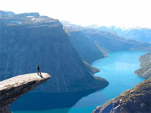 person standing over esoteric scene of lake