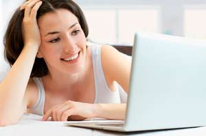 Woman relaxing while reading her online dating messages